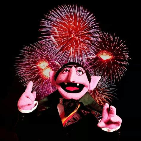 A Man In A Tuxedo With Fireworks Behind Him Giving The Thumbs Up Sign