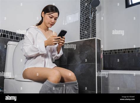 Woman Sitting On Toilet Using Hi Res Stock Photography And Images Alamy
