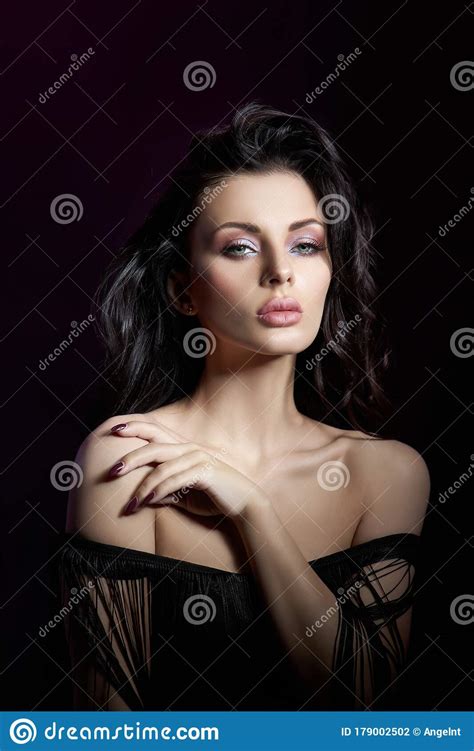 Portrait Of A Brunette Woman With A Chic Lush Wavy Hair Plump Lips