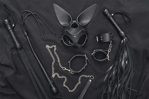 Explore The World Of Kinky Play Top View Of Bdsm Leather Kit Whips Handcuffs Mask And Chain