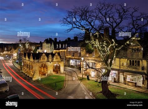 Market Hall And Cotswold Stone Cottages Along High Street At Dusk