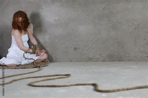 Young Girl Tied Up On The Floor The Abducted Girl The Victim Of Violence Sits On The Floor