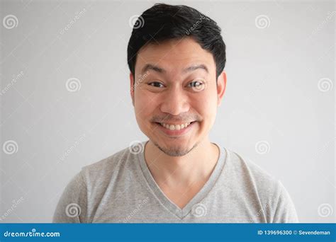 Funny Tricky Awkward Smirk Face Of Man In Grey T Shirt Stock Photo