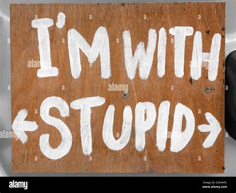 Wooden Board With Im With Stupid Sign Written In White Paint Stock