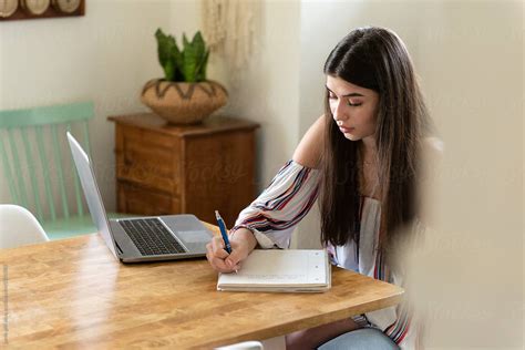 teenage girl doing homework by stocksy contributor jamie grill atlas stocksy