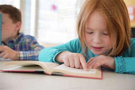 Caucasian Student Reading In Classroom Stock Photo Dissolve