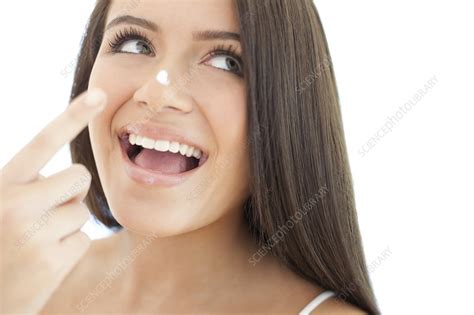 applying face cream stock image f003 4715 science photo library