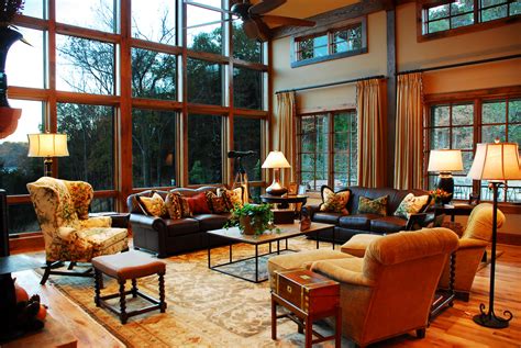 A Living Room Filled With Lots Of Furniture And Large Windows