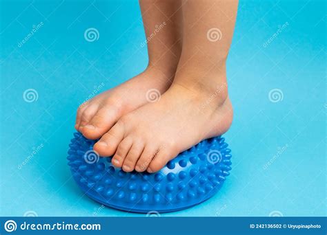 Childrenand X27s Feet With A Blue Balancer On A Light Blue Background