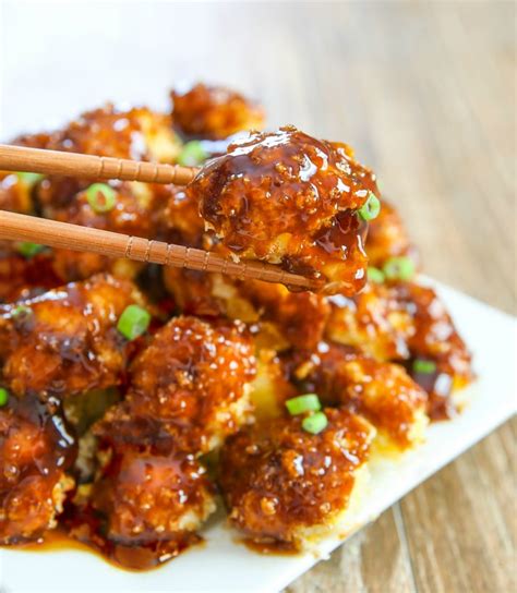 These baked buffalo cauliflower bites are delicious and make a super fun and healthy snack for super bowl sunday. Baked Orange Cauliflower - Kirbie's Cravings