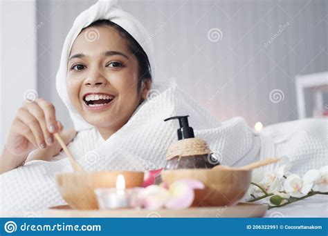 Smiling Asian Woman In White Headscarf And Bath Towel Lie Down And