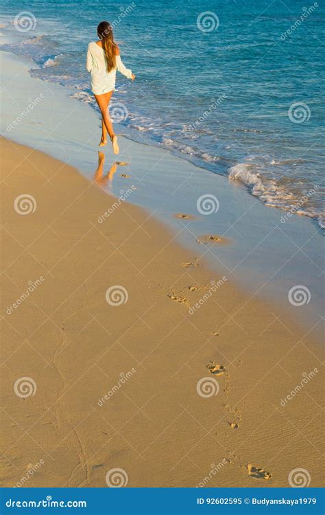 girl runs along the surf line stock image image of coast ocean 92602595