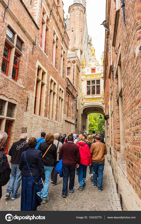 Any big celebration in belgium, both at home and in the streets. People on the old street of Bruges, Belgium - Stock Editorial Photo © dvoevnore #132432770