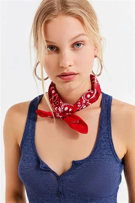 A Woman Wearing A Blue Tank Top With A Red Bandana Around Her Neck And Chest
