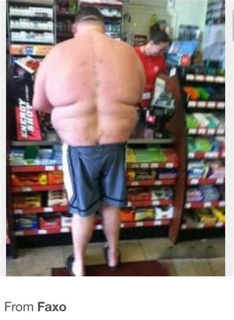 A Man Standing In Front Of A Store With His Back Turned To The Camera