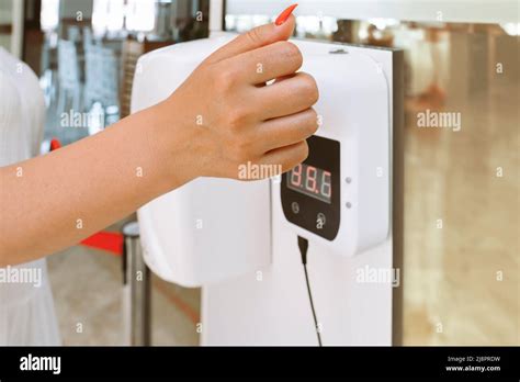 Lady Hand Checking Temperature Before Entering Restaurant With