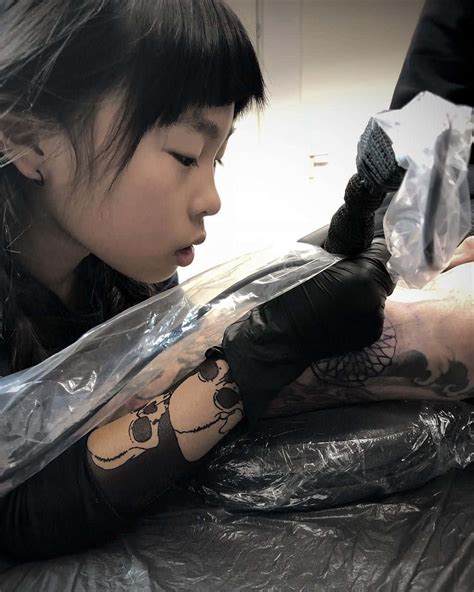 Download A Girl Getting Tattooed On Her Arm