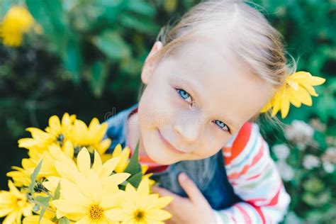 Little Girl With A Bouquet Of Yellow Wildflowers Stock Photo Image Of