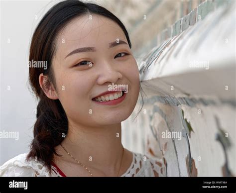Pretty Chinese Girl Smiles For The Camera At Bangkoks Wat Arun Temple