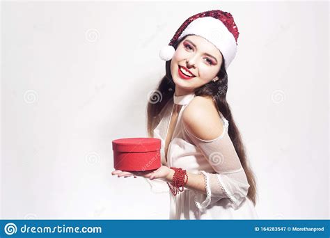 beautiful brunette girl in santa hat is holding a t stock image image of santa cute 164283547