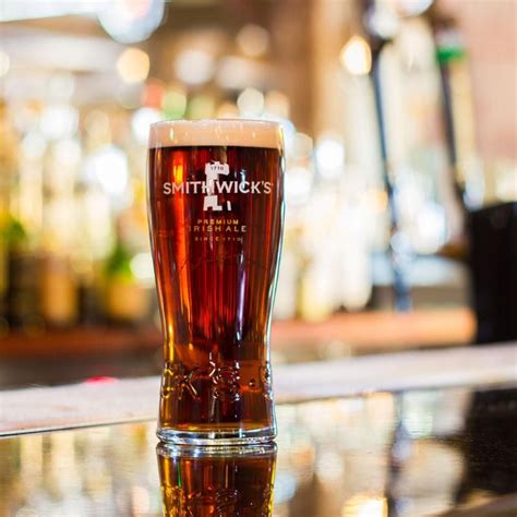 A Glass Of Beer Sitting On Top Of A Table