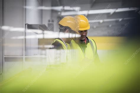 Male Supervisors Talking Looking Down In Factory Stock Image F030