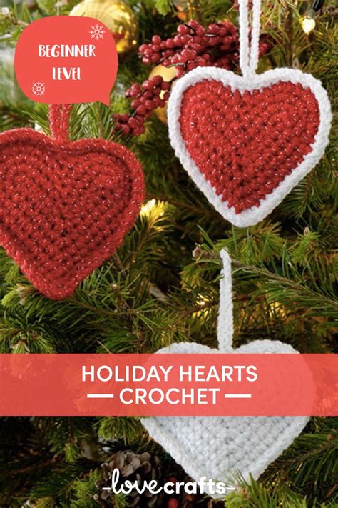 Two Crocheted Hearts Hanging From A Christmas Tree With The Text