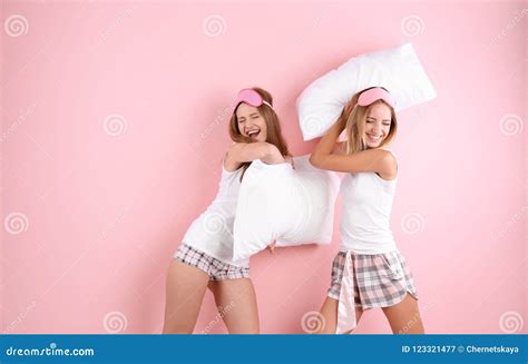 Two Young Women Having Pillow Fight Stock Image Image Of Beautiful