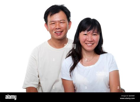 Asian Mature Couple Sitting With Smiling Face On White Background