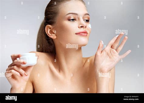 Gorgeous Woman With Moisturizing Cream On Her Face Photo Of Woman With