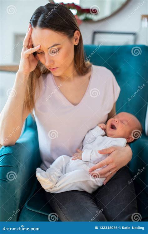 Stressed Mother Holding Crying Baby Suffering From Post Natal De Stock
