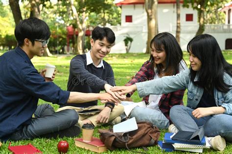Group Of University Students Stacking Hands Together Relationship