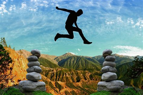 Hd Wallpaper Man Jumps In Between Two Cairns Risk Courage Balance