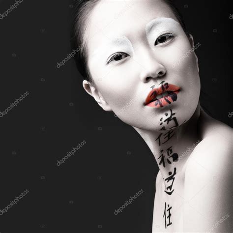 Beautiful Asian Girl With White Skin Red Lips And Hieroglyphics On Her
