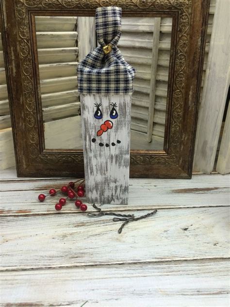 Make an easy diy wooden snowman using 4x4 blocks with this easy step by step tutorial. Diy Rustic Wood Snowman Block - Mixed Kreations