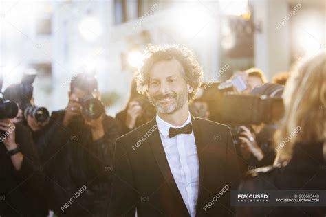Smiling Celebrity Being Photographed By Paparazzi At Event Slr Camera
