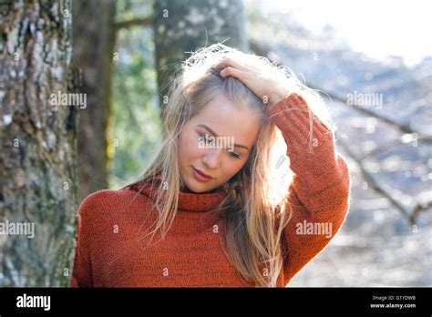 Young Girl With Long Blond Hair Leaning On A Tree Stock Photo Alamy