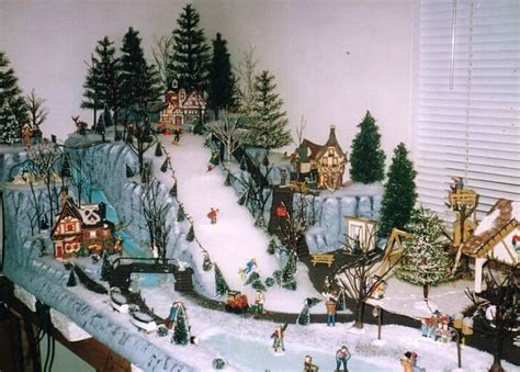 A Christmas Village Is Displayed On A Table