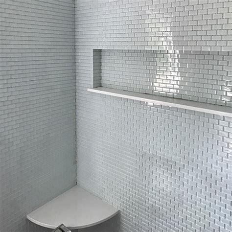 Subway tiles may look classic but it can give your space a timeless look because no matter how classic these are, even modern bathrooms still use it. White Mini Glass Subway Tile Shower Wall - Subway Tile Outlet