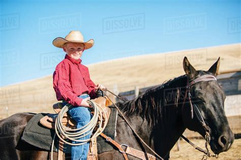 Caucasian Boy Riding Horse On Ranch Stock Photo Dissolve
