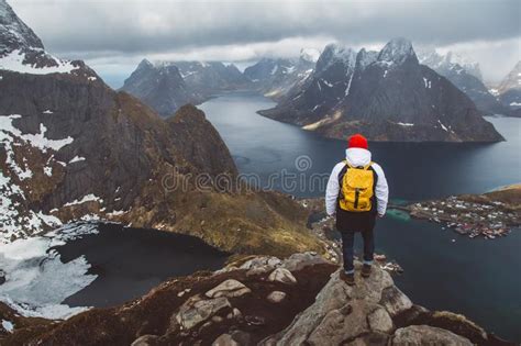Man Traveler Hiking On Reinebringen Mountain Ridge In Norway Lifestyle