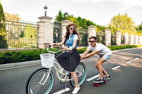 Young Couple Having Fun On Summer On Road Pretty Girl With Long Hair Driving A Bike Handsome