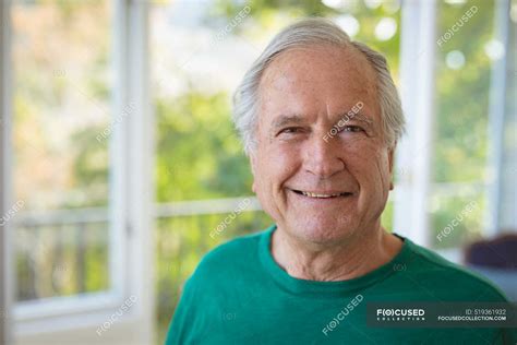 Portrait Of Smiling Senior Caucasian Man Looking At Camera At Home Spending Time At Home Alone