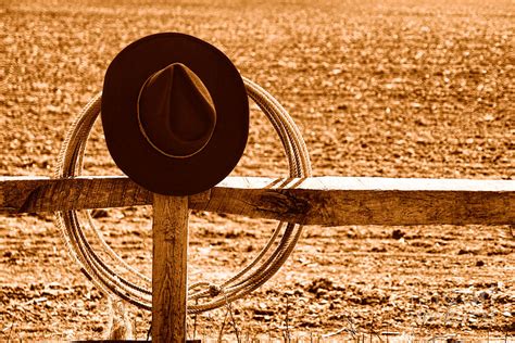 Hat And Lasso On Fence Sepia Photograph By Olivier Le Queinec Fine