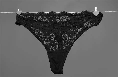 Premium Photo Womans Erotic Black Underwear Panties Hanging On Rope Isolated On Green