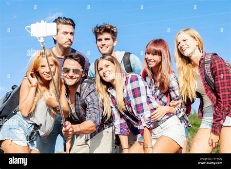 Group Of Friends Taking A Self Portrait With Selfie Stick Stock Photo