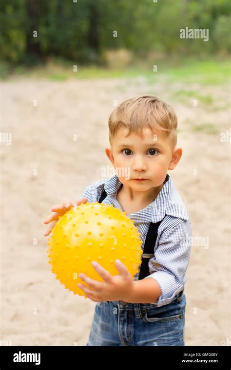 Child Holding Ball Hi Res Stock Photography And Images Alamy