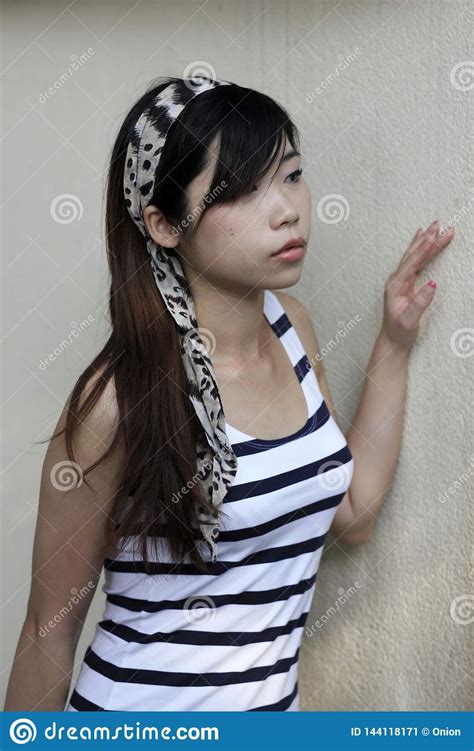 Beautiful Asian Woman Looking To The Side With A Headscarf On Her Head