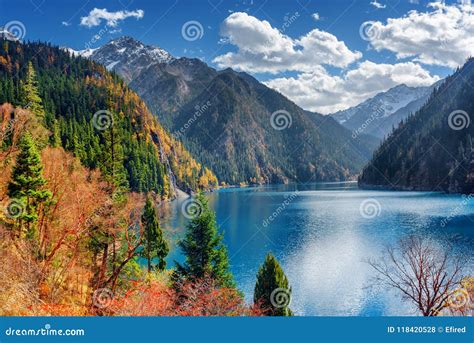 Beautiful View Of The Long Lake Among Colorful Fall Woods Stock Photo