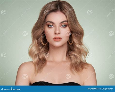 A Beautiful Young Woman With Shiny Wavy Blonde Hair Stock Photo Image